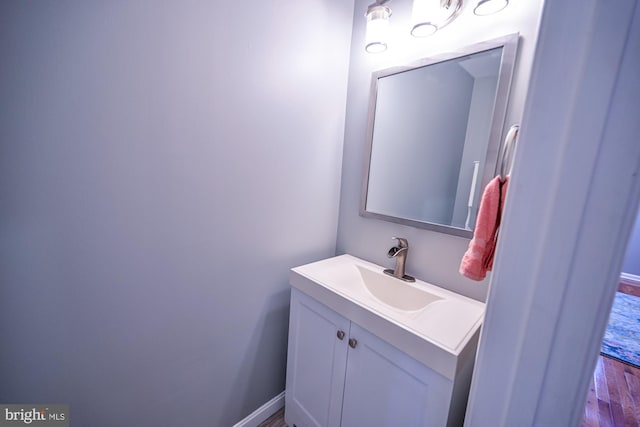 bathroom with hardwood / wood-style flooring and vanity