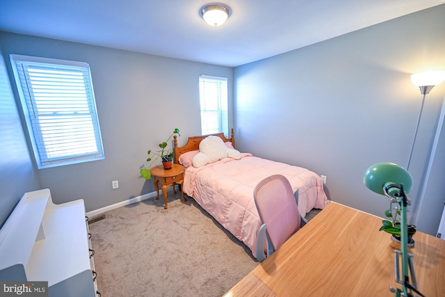 carpeted bedroom featuring multiple windows