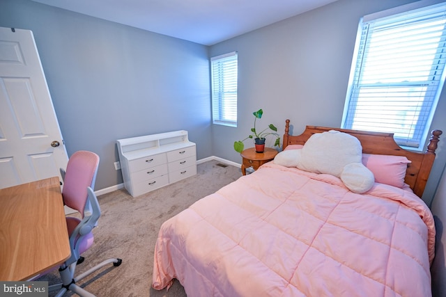 carpeted bedroom featuring multiple windows