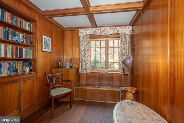 living area with wood walls, beamed ceiling, dark wood-type flooring, built in shelves, and coffered ceiling