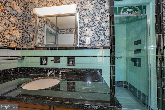 bathroom featuring tile walls, vanity, and tiled shower