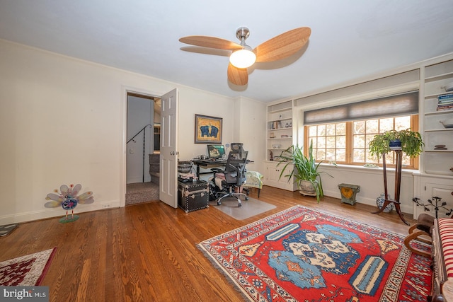 office with ceiling fan, hardwood / wood-style flooring, and built in features