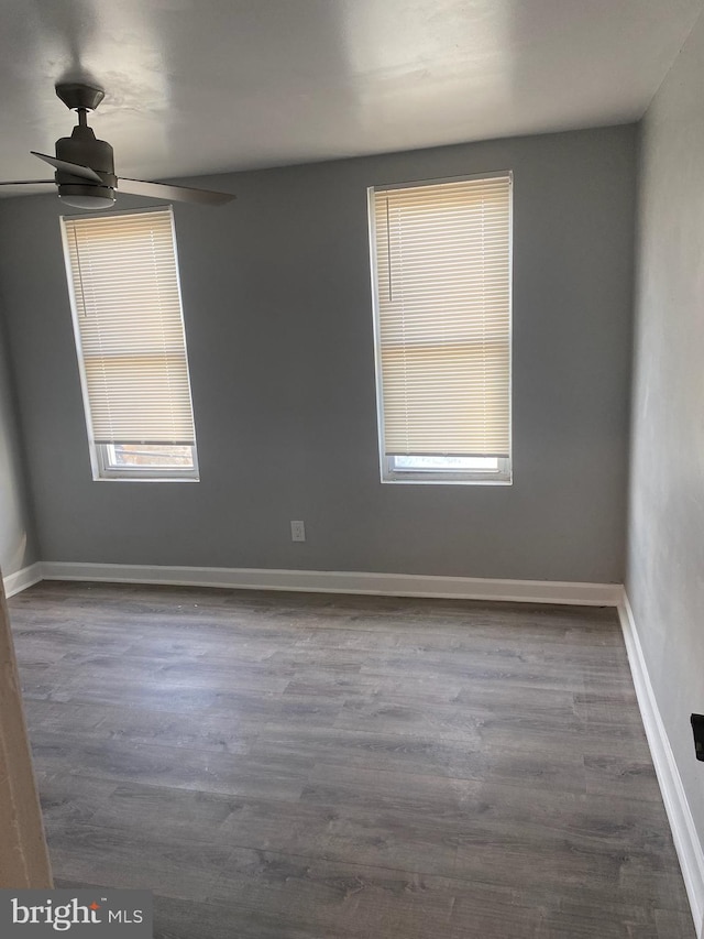 spare room with ceiling fan and hardwood / wood-style flooring