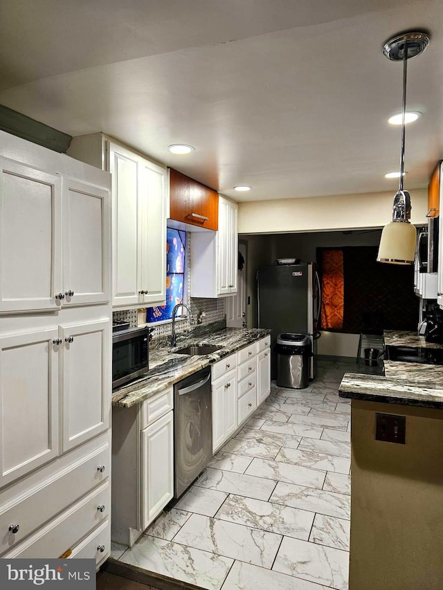 kitchen with white cabinets, sink, backsplash, and stainless steel appliances