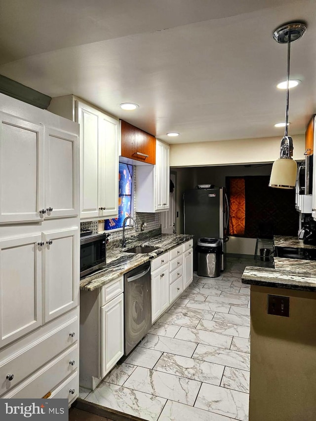 kitchen with recessed lighting, a sink, marble finish floor, white cabinets, and appliances with stainless steel finishes