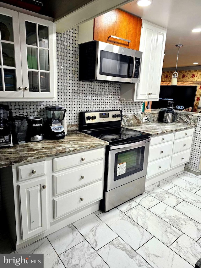 kitchen with white cabinets, glass insert cabinets, stainless steel appliances, stone counters, and marble finish floor