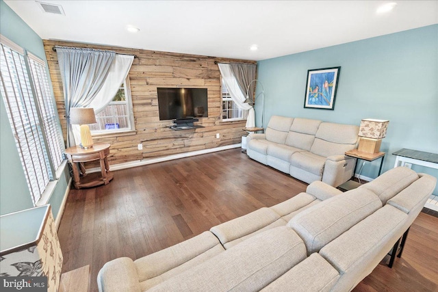 living room featuring wooden walls and wood-type flooring