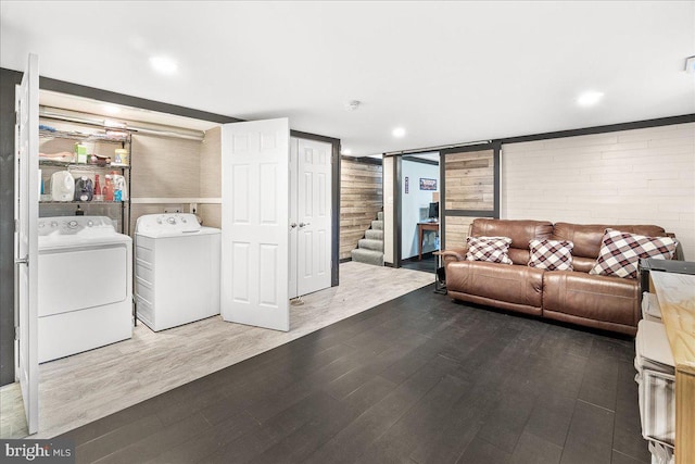 clothes washing area with hardwood / wood-style flooring and separate washer and dryer