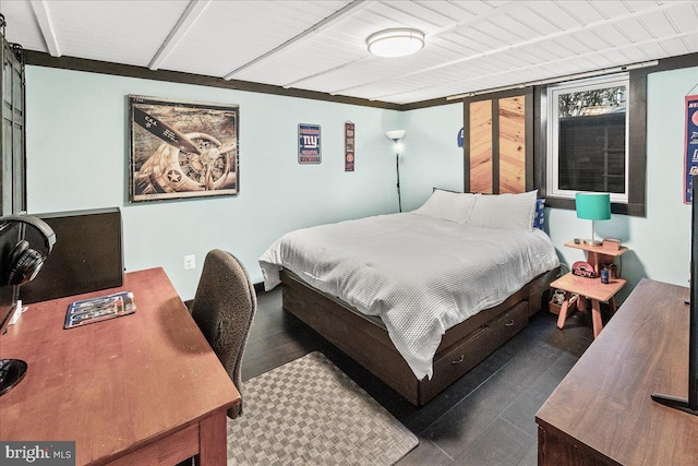 bedroom with dark hardwood / wood-style floors