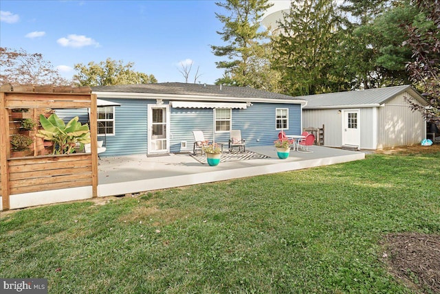 back of house featuring a patio and a lawn