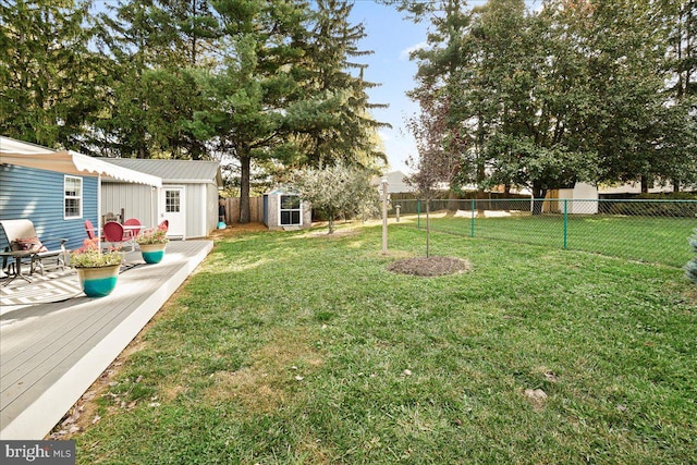 view of yard featuring a storage shed and a wooden deck