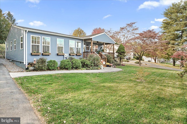 view of front of home with a porch and a front lawn