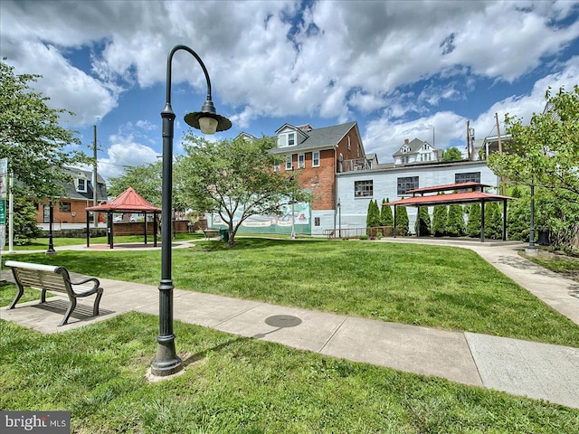 view of property's community featuring a yard and a gazebo