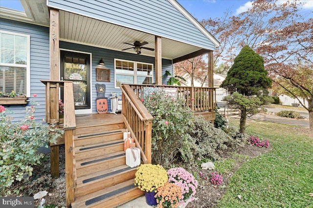 view of exterior entry featuring ceiling fan and a porch