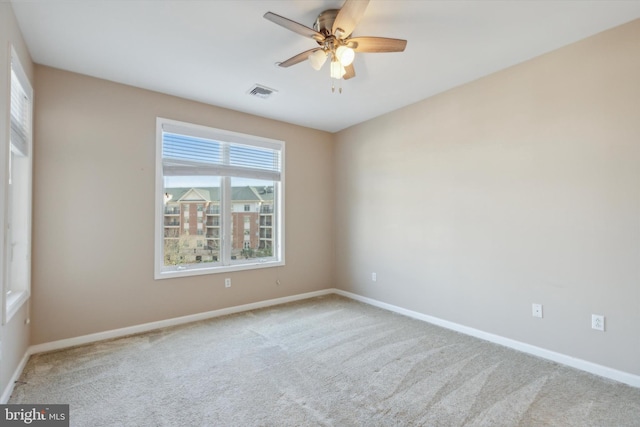 unfurnished room featuring light colored carpet and ceiling fan