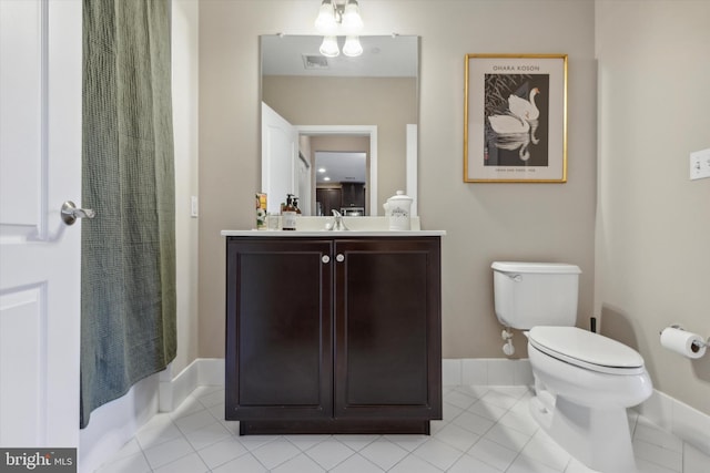 bathroom featuring toilet, vanity, tile patterned floors, and a shower with shower curtain