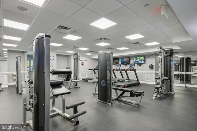 exercise room featuring a drop ceiling