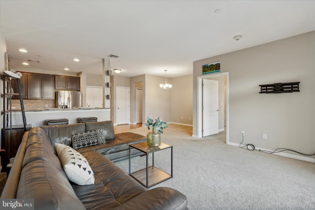 living room featuring a chandelier and light carpet