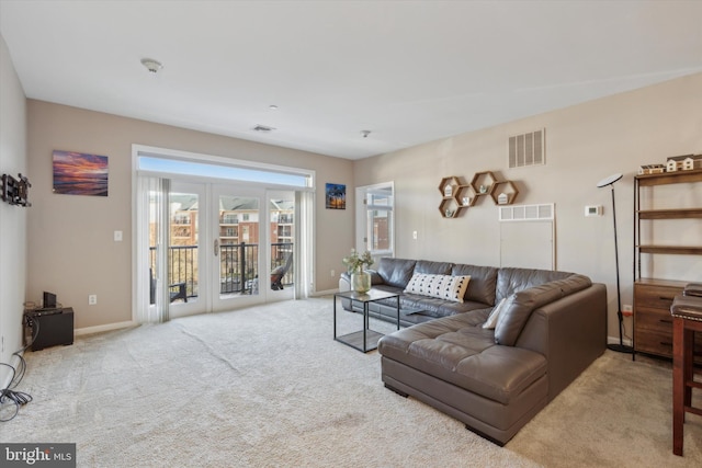 carpeted living room with french doors