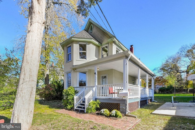 victorian house with a porch and a front yard