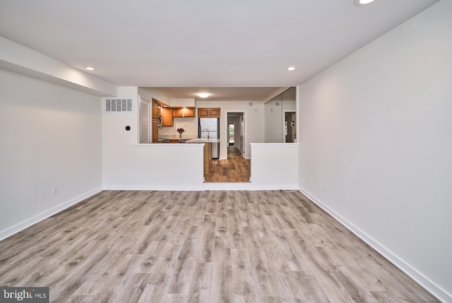 unfurnished living room with light wood-type flooring