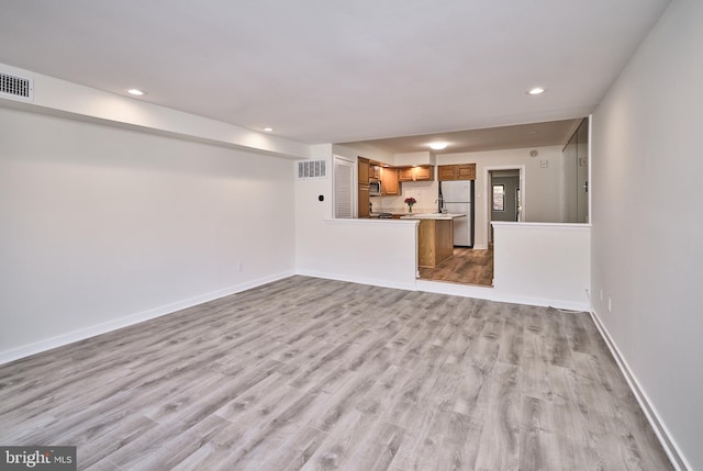 unfurnished living room with light hardwood / wood-style flooring