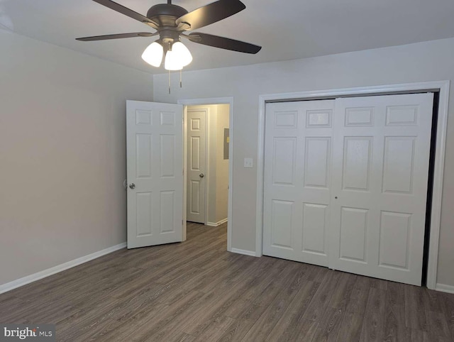 unfurnished bedroom with a closet, ceiling fan, and dark hardwood / wood-style floors