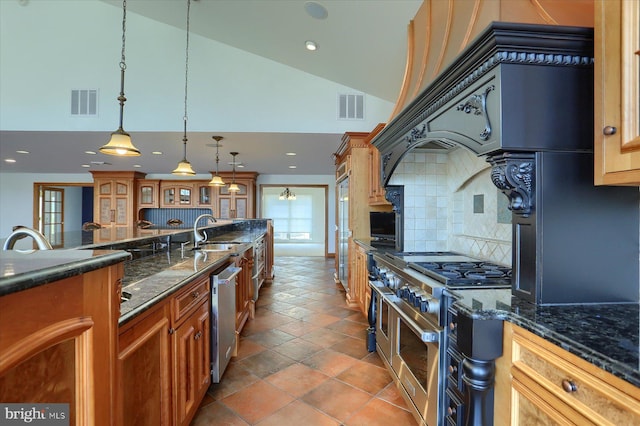 kitchen featuring decorative backsplash, stainless steel appliances, sink, pendant lighting, and high vaulted ceiling