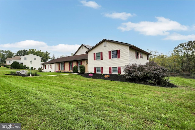 tri-level home with a front yard