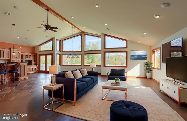 living room with a wealth of natural light, wood-type flooring, and high vaulted ceiling