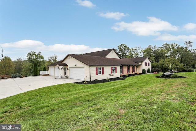 view of front of property with a front yard and a garage