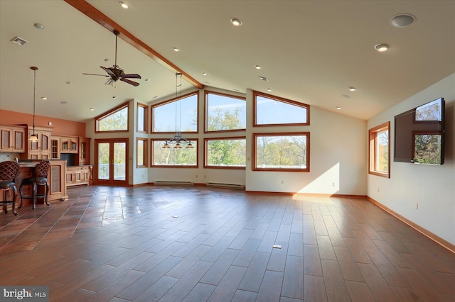 unfurnished living room with a wealth of natural light, dark hardwood / wood-style floors, high vaulted ceiling, and ceiling fan