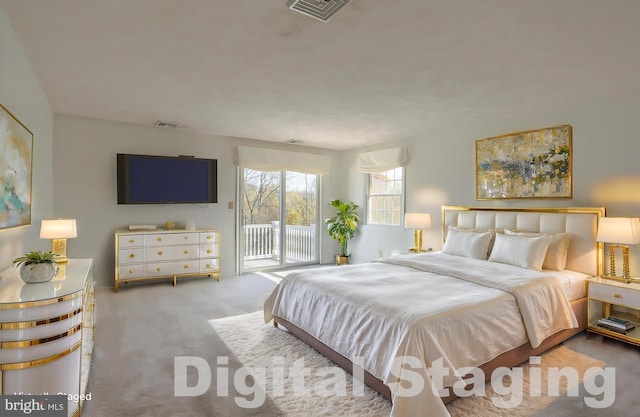 bedroom featuring access to exterior and carpet floors