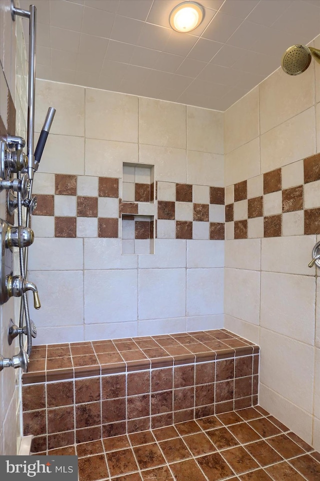 bathroom with walk in shower and tile walls