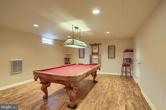 game room with light hardwood / wood-style floors, heating unit, and pool table