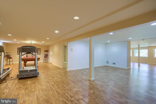 workout room with light hardwood / wood-style floors