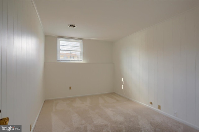 carpeted empty room featuring ornamental molding