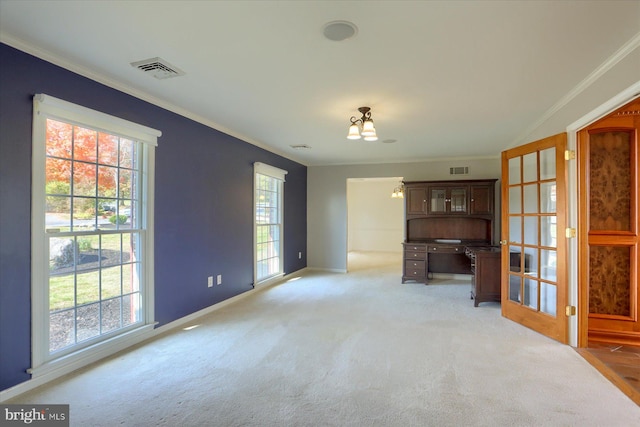 unfurnished living room with a wealth of natural light, ornamental molding, and built in desk