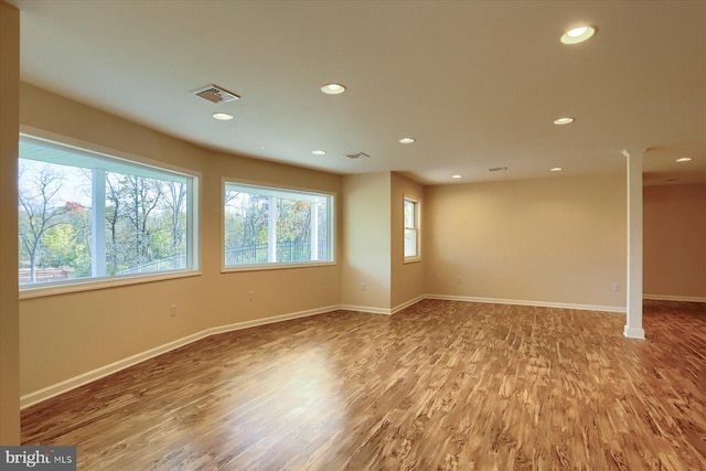 empty room featuring hardwood / wood-style floors and plenty of natural light