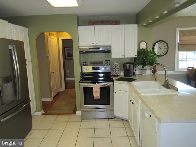 kitchen with sink, appliances with stainless steel finishes, white cabinets, and light tile patterned flooring