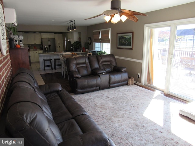 living room with ceiling fan and an AC wall unit