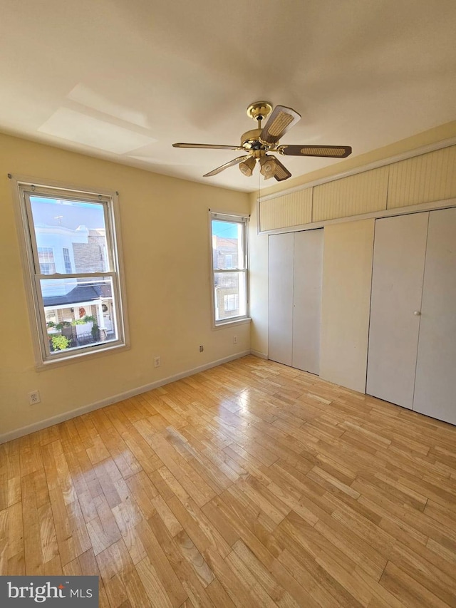 unfurnished bedroom with light hardwood / wood-style floors and ceiling fan