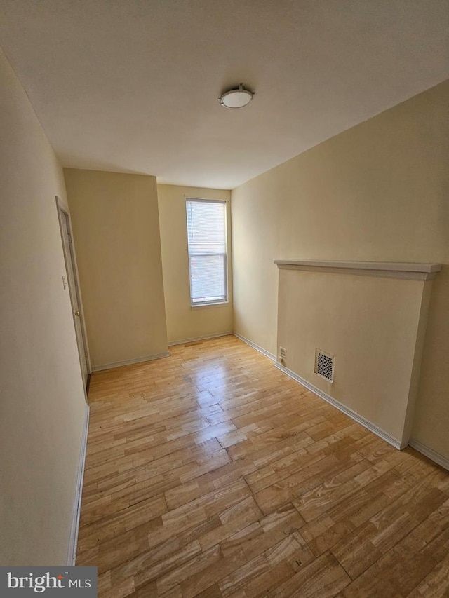 spare room with light hardwood / wood-style flooring