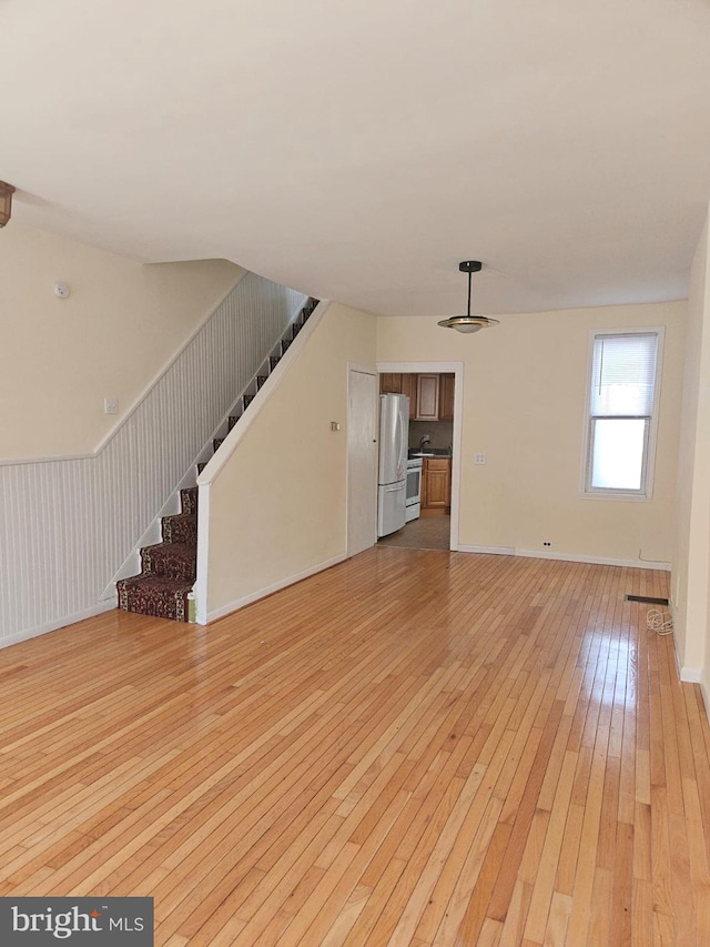 unfurnished living room with light wood-type flooring