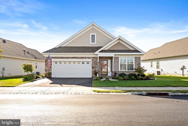 craftsman-style home with a front yard, central AC, and a garage