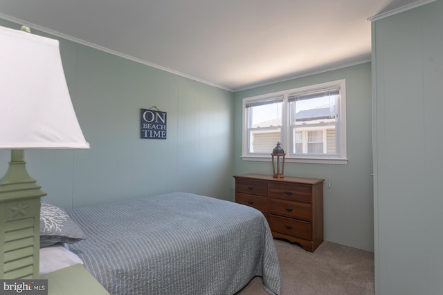 carpeted bedroom featuring crown molding