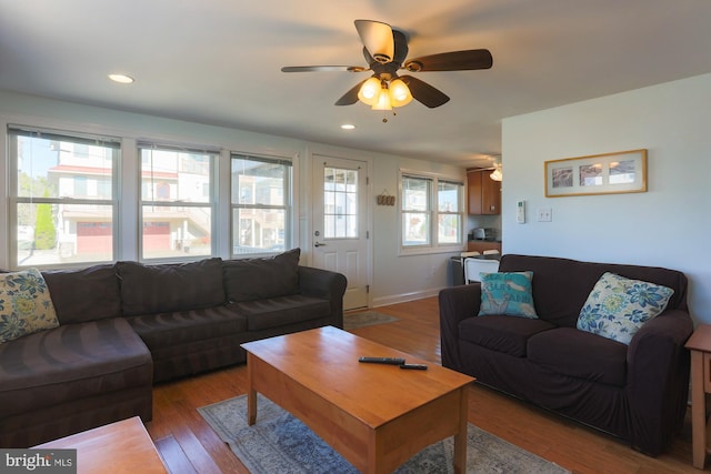 living room featuring light hardwood / wood-style floors and ceiling fan