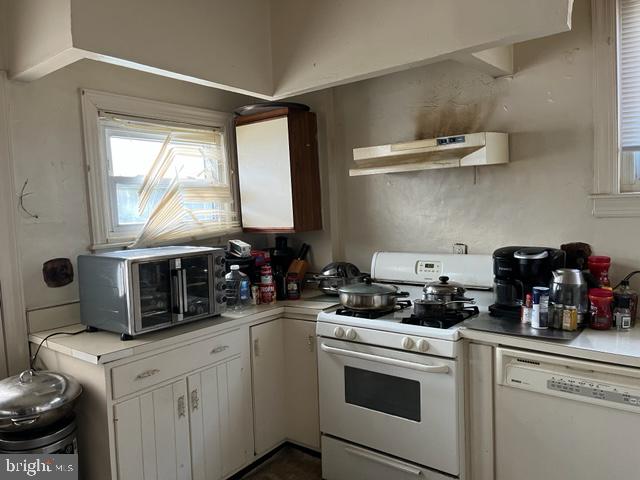 kitchen with white cabinets and white appliances