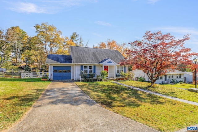 view of front of home with a front yard and a garage