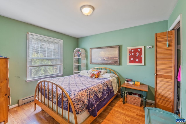 bedroom featuring light hardwood / wood-style flooring and baseboard heating